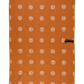 This picture is showing one side of the double sided waffle weave design.  This side features an orange hue with beige polka dots.  It also shows a hook that you can use to hang the towel to dry.