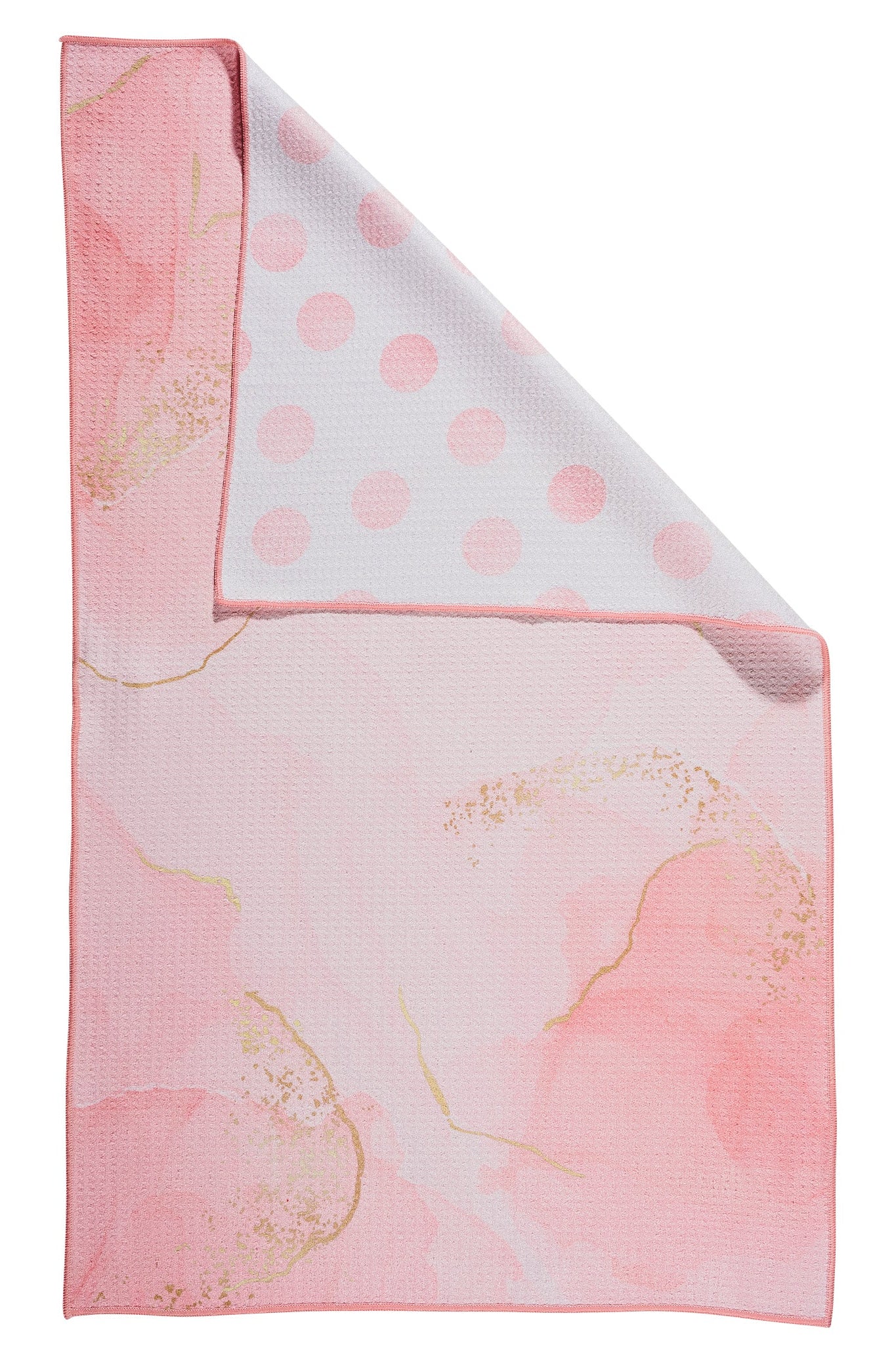 A folded pink and white waffle-weave cloth napkin with a watercolor floral pattern and gold glitter accents on one side, and a light pink polka dot pattern on the reverse side, shown against a plain white background.