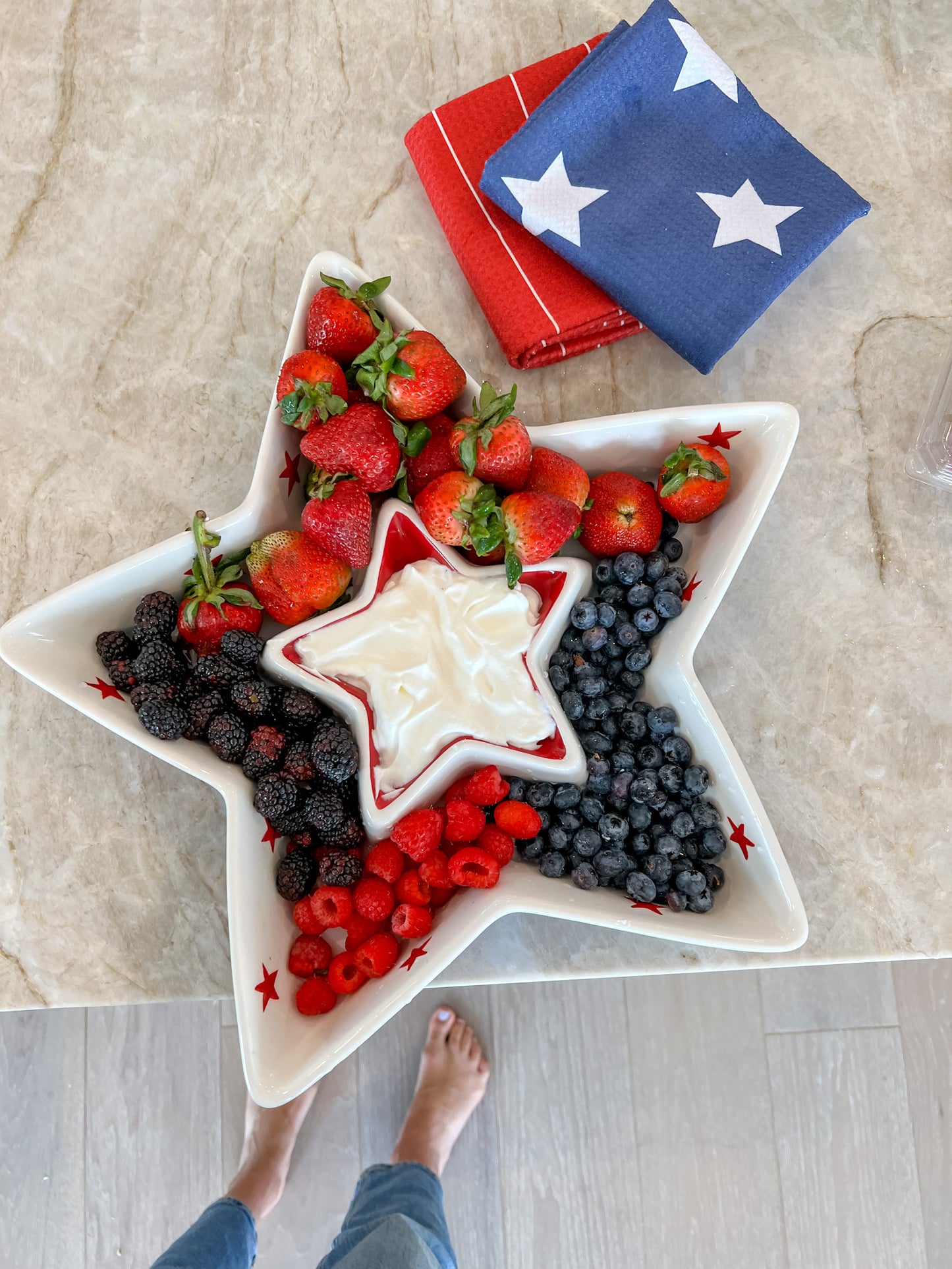 A White star plate with a fruit dessert and our patriotic towel folded on the side.